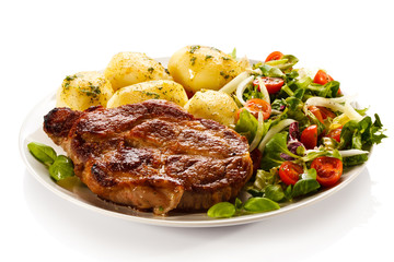 Grilled steak, boiled potatoes and vegetable salad