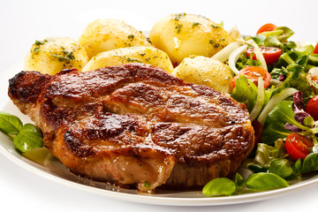 Grilled steak, boiled potatoes and vegetable salad