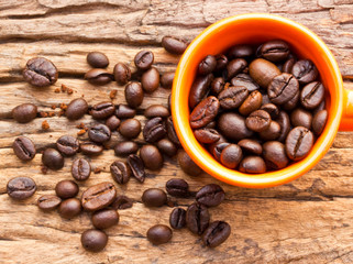 Coffee and cup on grunge wooden background Fresh coffee beans on