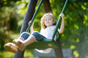 Adorable girl having fun on a swing © MNStudio