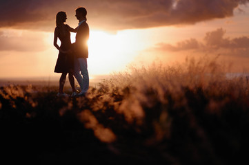 Fototapeta na wymiar Young couple enjoying the sunset