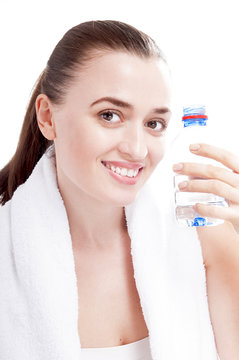 Happy smiling woman with bottle of water covering white backgrou
