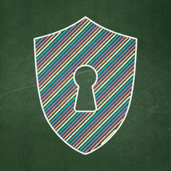 Safety concept: Shield With Keyhole on chalkboard background