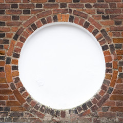 Circular frame in old brick wal