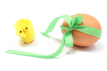 Easter chicken and egg with green ribbon. White background