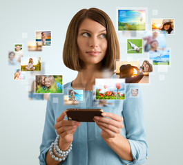 Portrait of young happy woman sharing her photo and video files