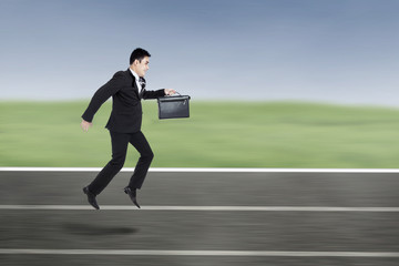 Businessman Running On A Racing Track