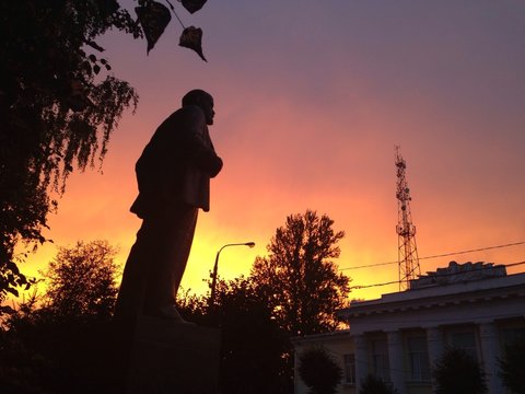 Lenin statue with dramatic red sky