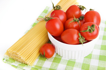 ingredients: сherry tomatoes in a bowl and  spaghetti on green