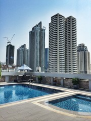 Fototapeta na wymiar Bangkok City skyline from rooftop pool deck