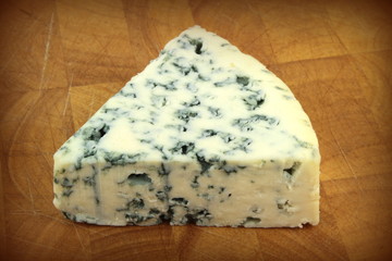 Blue cheese on wooden background