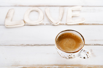 LOVE sign letters with espresso coffee in white cup,  old rustic