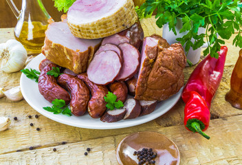 plate various kinds sausages surrounded greens