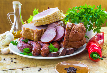plate various kinds sausages surrounded greens