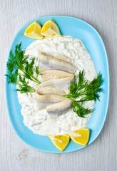 Herring with dill sauce and lemons