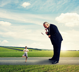 senior boss screaming at calm smiley woman