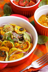 Pasta salad with tomatoes, olives and herbs