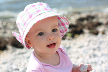 Baby girl on the sand beach