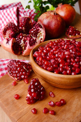 Ripe pomegranates on table close-up