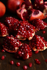 Ripe pomegranates on table close-up