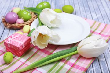 Easter table setting with tulips and eggs