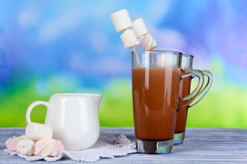 Hot chocolate with marshmallows, on blue background