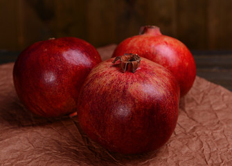 Fototapeta na wymiar Ripe pomegranates on table close-up
