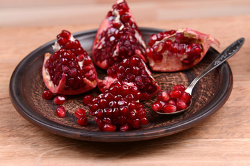 Ripe pomegranates on table close-up