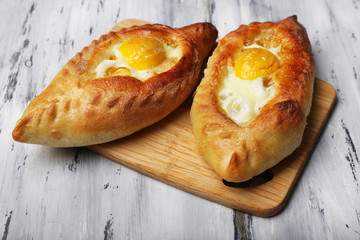 Ajarian khachapuri on wooden table close up