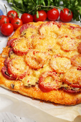 Homemade pizza on baking paper close up
