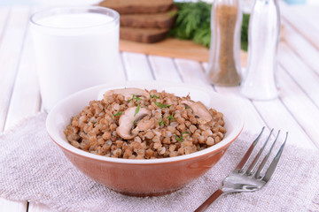 Boiled buckwheat in bowl on table close-up