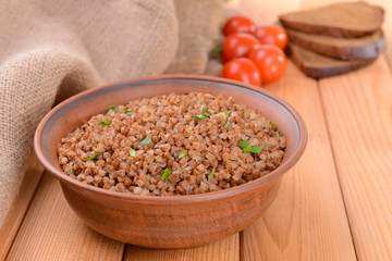 Boiled buckwheat in bowl on table close-up