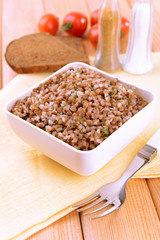 Boiled buckwheat in bowl on table close-up