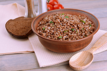Boiled buckwheat in bowl on table close-up
