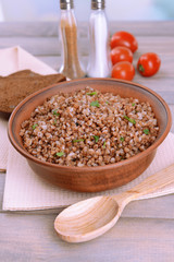 Boiled buckwheat in bowl on table close-up