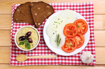 Bowl of tasty fresh hummus with olives
