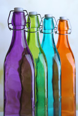 Colorful bottles on light background