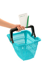 Fototapeta premium Woman hand holding a market basket with blank shopping list.
