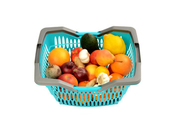 Blue plastic shopping basket full of groceries isolated on white