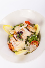 tasty fresh caesar salad with grilled chicken and parmesan