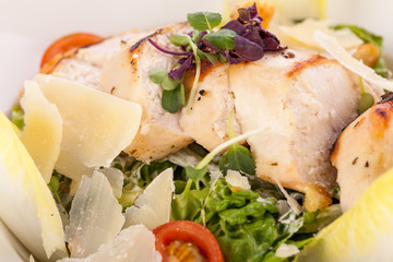 tasty fresh caesar salad with grilled chicken and parmesan