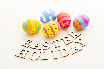 Colourful easter egg with wooden text