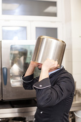 Chef cooking a vegetables stir fry over a hob