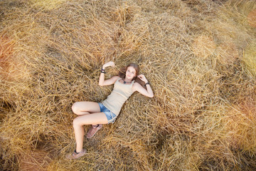 Beauty woman in the straw in field