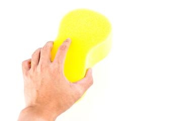 Hand holding sponge isolated on white background