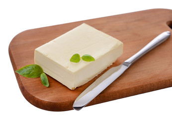 Tasty butter on wooden cutting board isolated on white