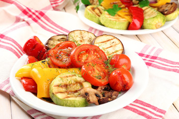 Delicious grilled vegetables on plate on table close-up