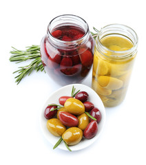 Tasty olives in glass jars, isolated on white