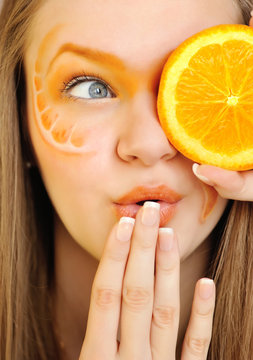 Young Beautiful Woman With Creative Orange Makeup With Orange