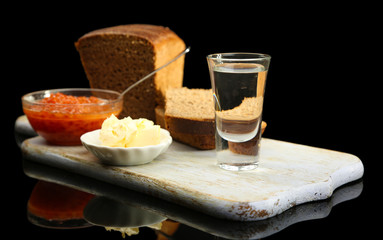 Composition with glasses of vodka, red caviar, fresh bread